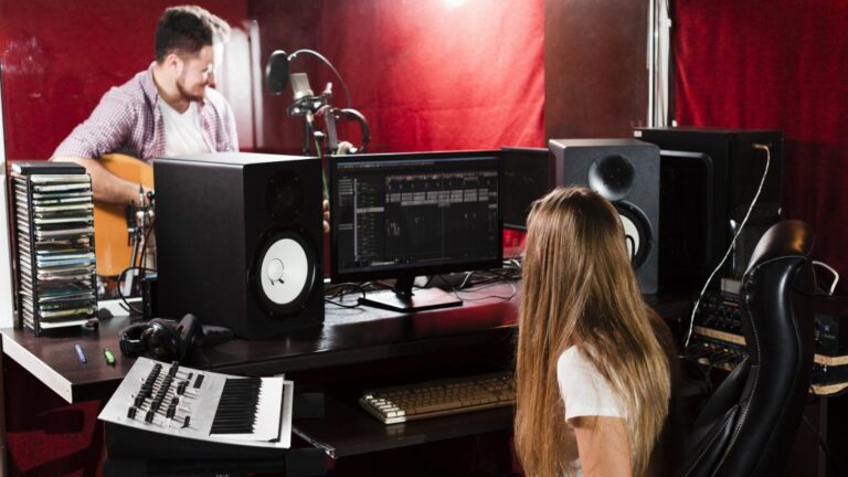 woman-records-guitar-guy-playing-studio-1024x576